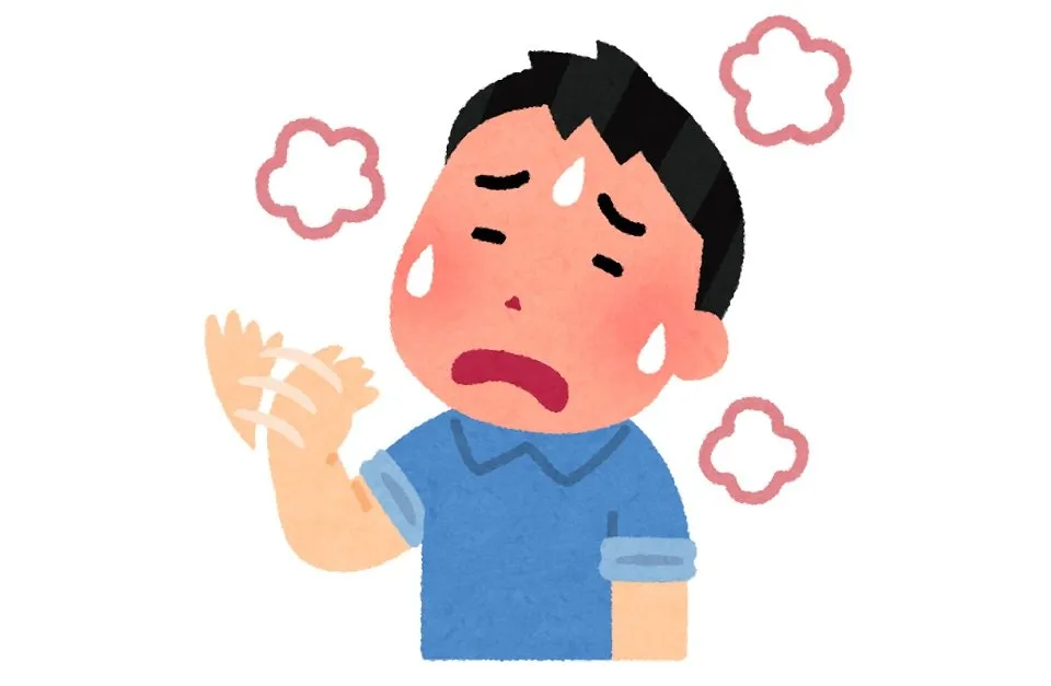 暑くて手で自分を仰ぐ男性